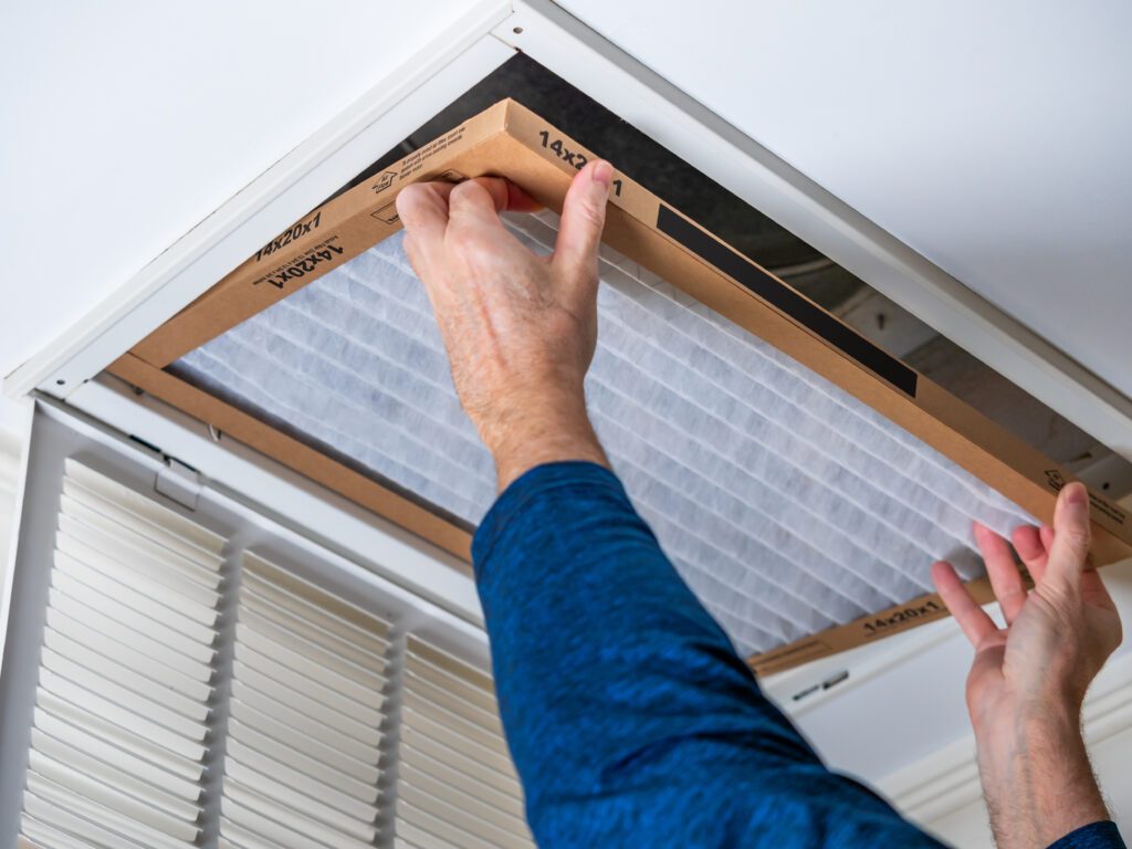 HVAC technician replacing a home air filter in Santa Monica