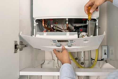 Heating technician repairing a residential boiler in Santa Monica