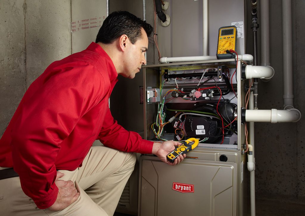 Heating technician diagnosing a furnace repair in Santa Monica