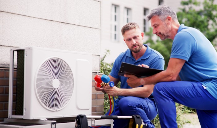 HVAC technicians installing an outdoor air conditioning unit in Santa Monica